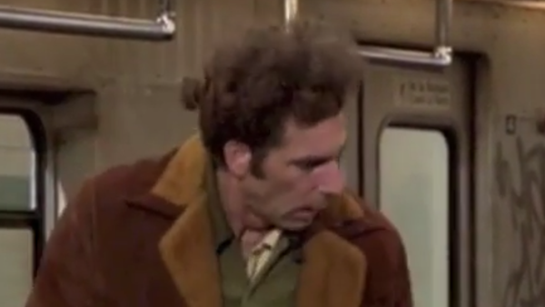 Kramer on the subway looking askance at another passenger